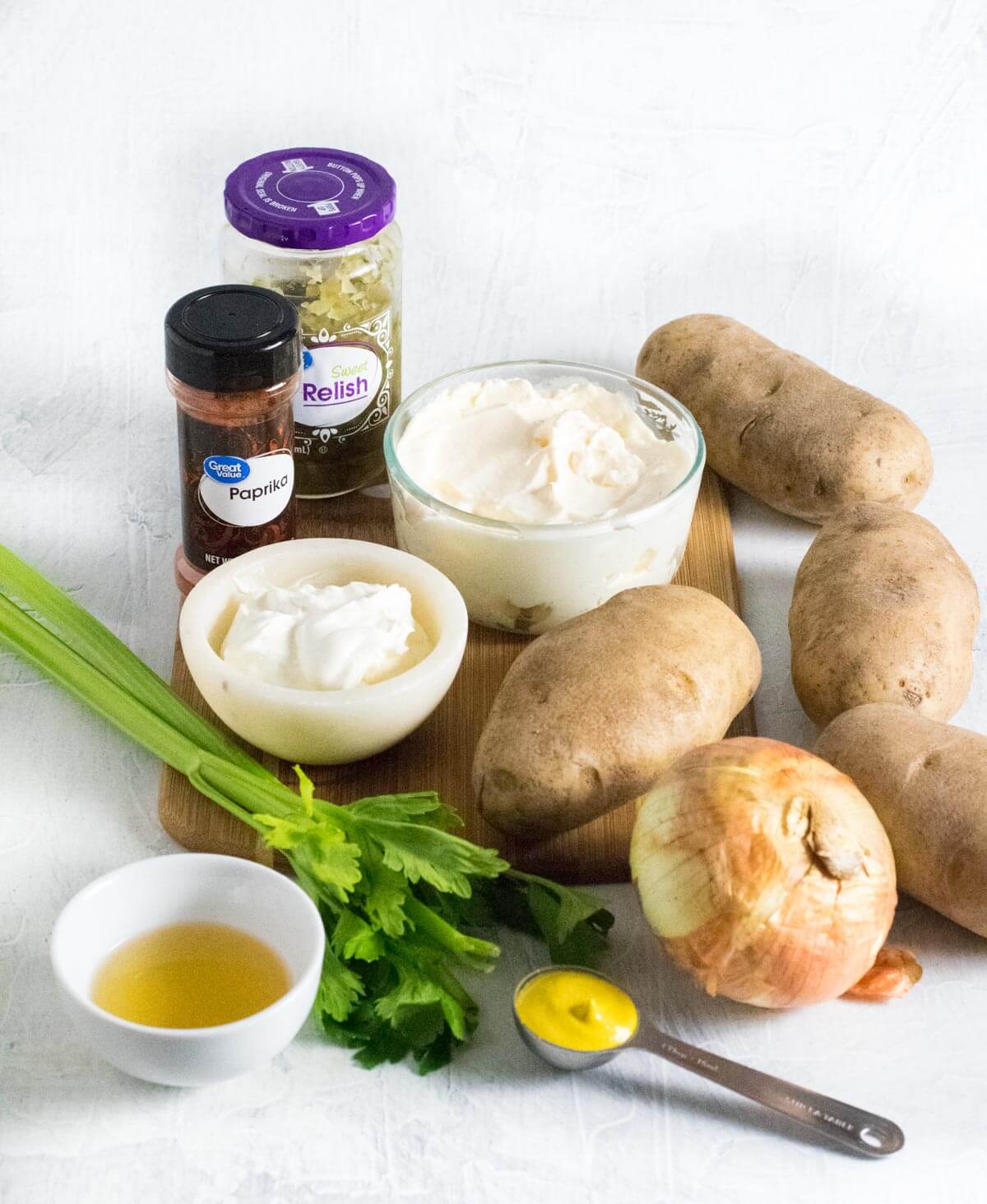 Showing potato salad ingredients without eggs.